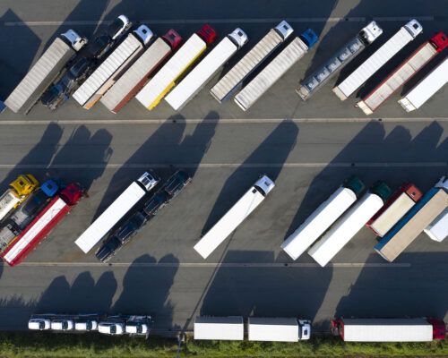 Heavy goods transportation - trucks in truck stop from above.